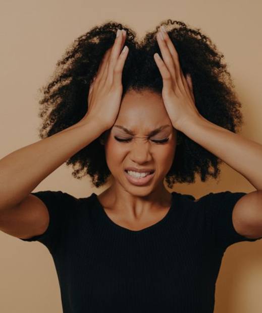 a woman holding her head and needing anger management