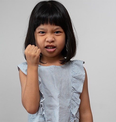 Angry girl holding up her first