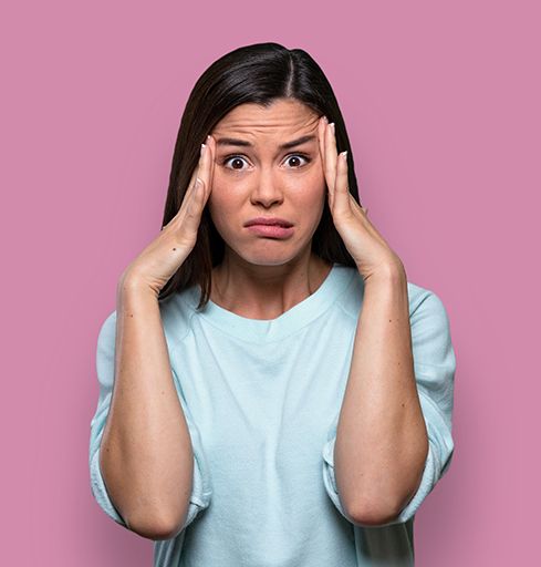 Overwhelmed woman touching the sides of her head