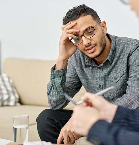 Young man expressing himself during psychiatric consultation