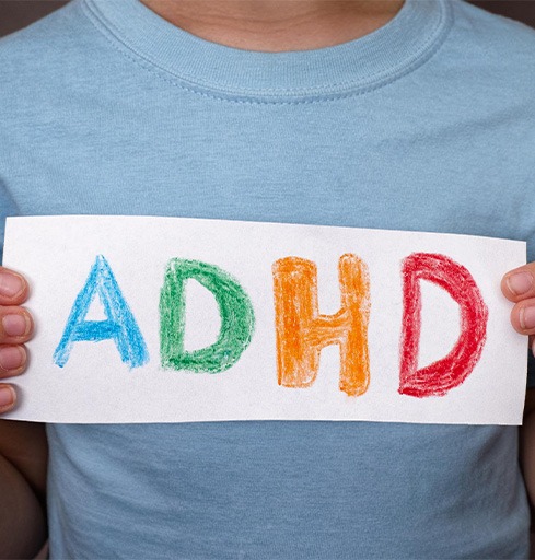Boy holding ADHD sign