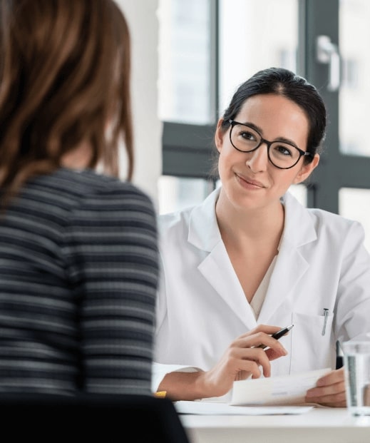 Team member greeting patient at reception desk