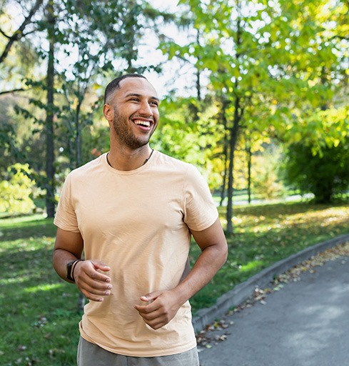 Happy man jogging outdoors