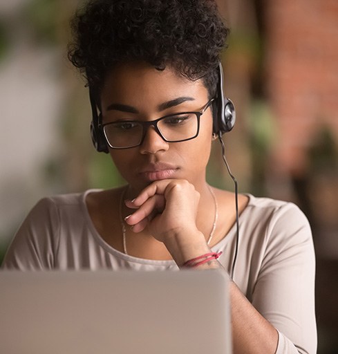 Woman concentrating as she works on her computer