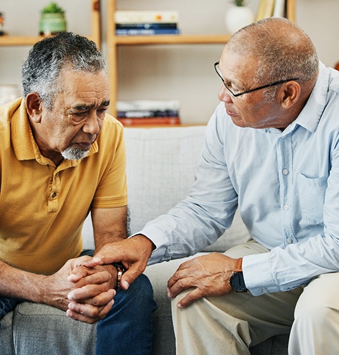 Sad older man talking with a friend