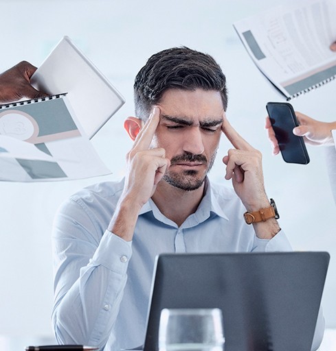 Tired man dealing with stress at work