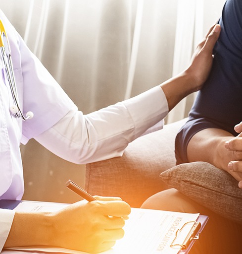 Medical professional taking notes and comforting patient
