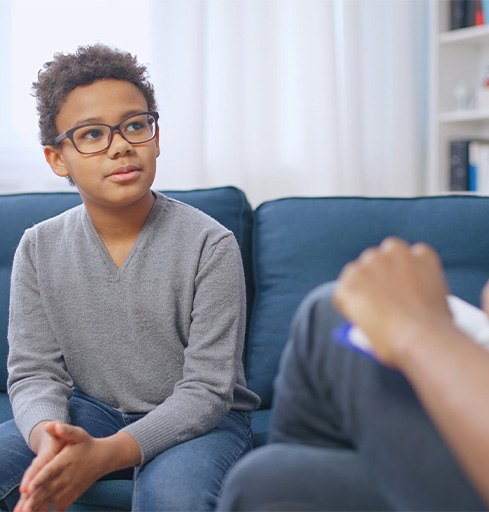 Preteen boy talking to mental health professional