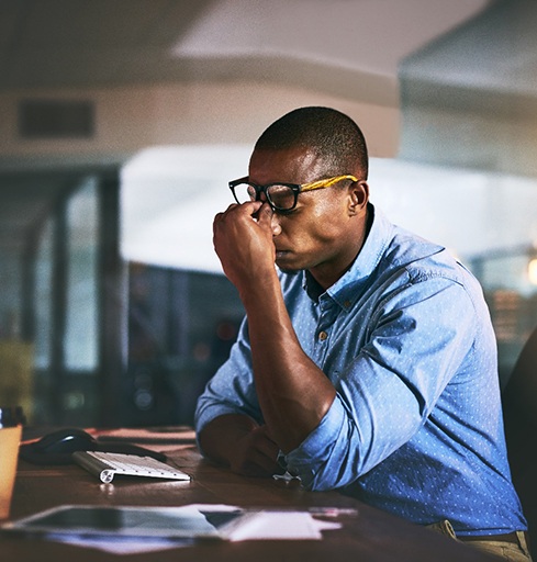 Man at work appearing stressed