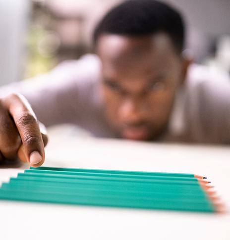 man with OCD fixing pencils 