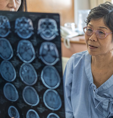 patient with neurological disorder looking at X-ray 