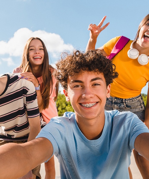 Happy teenage friends talking a selfie