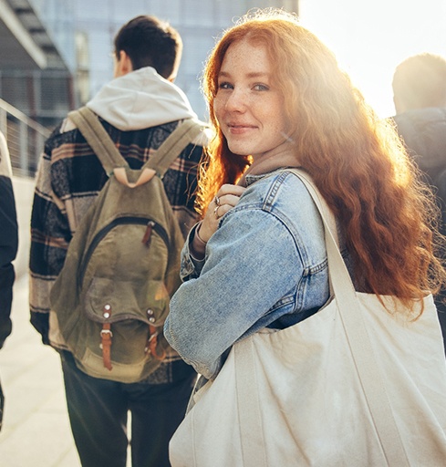 Happy teen girl looking over her shoulder