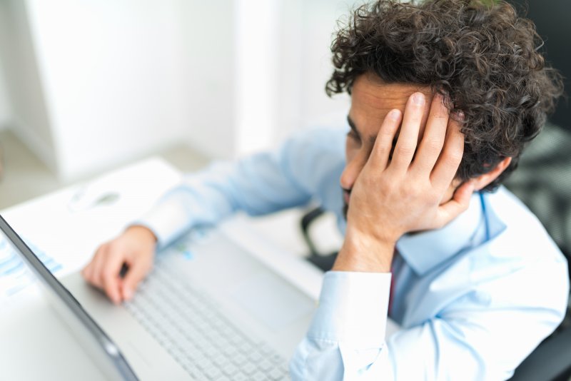 a man covering his face and lacking motivation